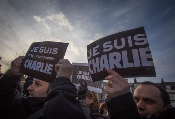 BRISTOL, UNITED KINGDOM - JANUARY 10: People hold Je Suis Charlie placards as they gather at a vigil to show support for the victims of the French terror attacks on January 10, 2015 in Bristol, Englan ...