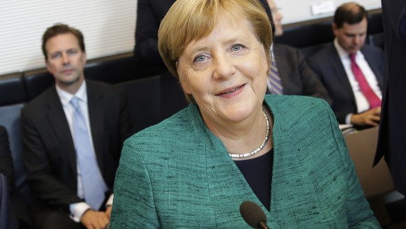 Christian Democratic Union Chairwoman and German Chancellor Angela Merkel arrives for a faction meeting of her ruling Christian Union parties at the Reichstag building in Berlin, Tuesday, Sept. 25, 20 ...