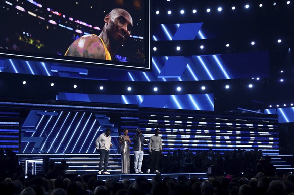 Nathan Morris, from left, Wanya Morris, Shawn Stockman, of Boyz II Men‎, and Alicia Keys, second left, sing a tribute in honor of the late Kobe Bryant, seen on screen, at the 62nd annual Grammy Awards ...