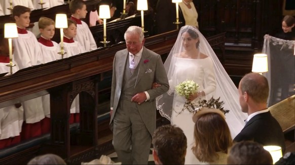 In this frame from video, Meghan Markle walks down the aisle with Prince Charles for her wedding ceremony at St. George&#039;s Chapel in Windsor Castle in Windsor, near London, England, Saturday, May  ...