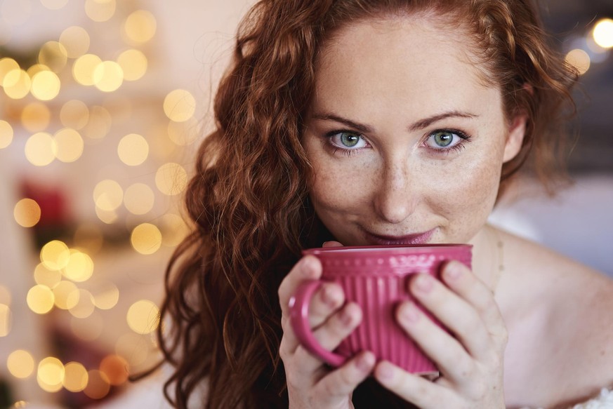 Portrait of beautiful girl drinking tea or coffee