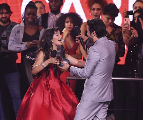 Camila Cabello, left, wins Best Artist on stage during the MTV EMA&#039;s 2018 at Bilbao Exhibition Centre on Sunday, Nov. 4, 2018, in Bilbao, Spain. (Stuart C. Wilson, pool photo via AP)