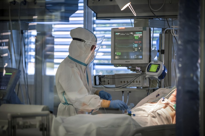 A medical staffer tends to a patient in the intensive care unit of the Circolo Hospital and Macchi Foundation of Varese, Italy, Friday, Oct. 30, 2020. Italy on Friday added more than 31,000 confirmed  ...
