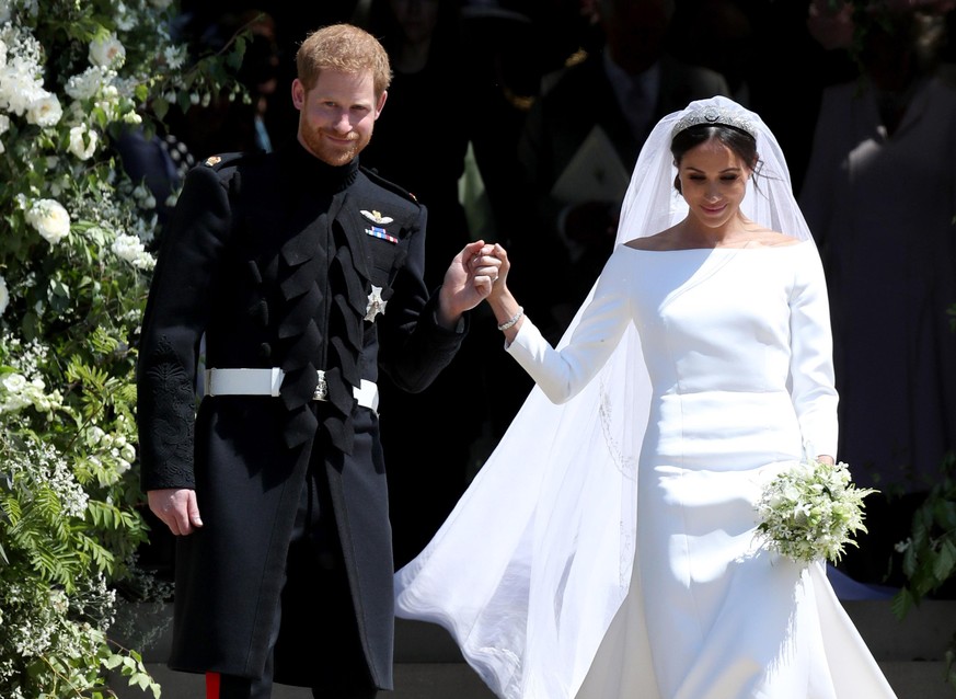 WINDSOR, UNITED KINGDOM - MAY 19: Prince Harry, Duke of Sussex and the Duchess of Sussex depart after their wedding ceremony at St George&#039;s Chapel at Windsor Castle on May 19, 2018 in Windsor, En ...