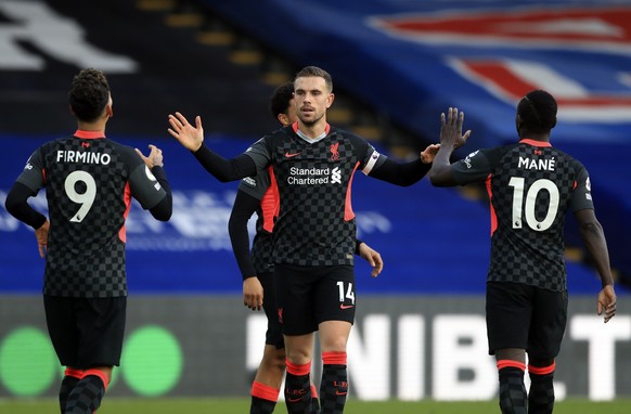 Liverpool&#039;s Jordan Henderson, centre, celebrates with teammates after scoring his side&#039;s fourth goal during the English Premier League soccer match between Crystal Palace and Liverpool at Se ...
