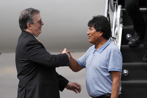 Mexican Foreign Minister Marcelo Ebrard, left, welcomes former Bolivian President Evo Morales upon his arrival in Mexico City, Tuesday, Nov. 12, 2019. Mexico granted asylum to Morales, who resigned on ...