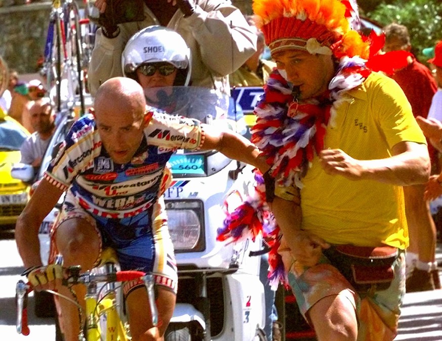 FILE - In this Saturday July 19, 1997 file picture Marco Pantani of Italy tries to get away from a spectator as he climbs towards victory in the 13th stage of the Tour de France cycling race between S ...