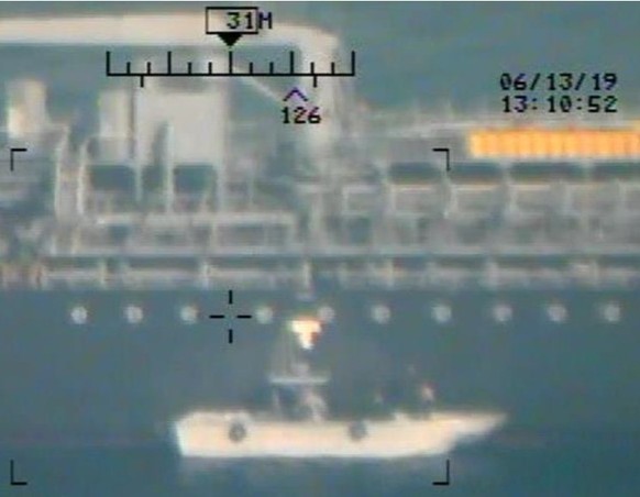 A U.S. military image released by the Pentagon in Washington on June 17, which is says was taken from a U.S. Navy MH-60R helicopter in the Gulf of Oman, shows personnel that the Pentagon says are memb ...