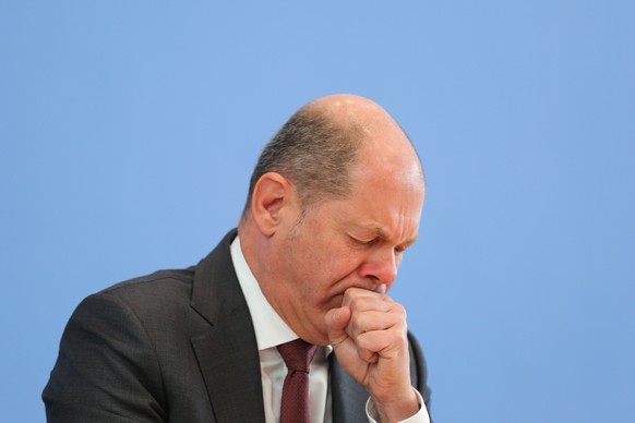 BERLIN, GERMANY - MARCH 23: Finance Minister Olaf Scholz coughs as he speaks to the media about the German government&#039;s proposed new federal budget on March 23, 2020 in Berlin, Germany. The budge ...