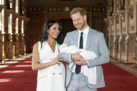 FILE - Britain&#039;s Prince Harry and Meghan, Duchess of Sussex, pose with their newborn son Archie Harrison Mountbatten-Windsor in St George&#039;s Hall at Windsor Castle, Windsor, south England, on ...