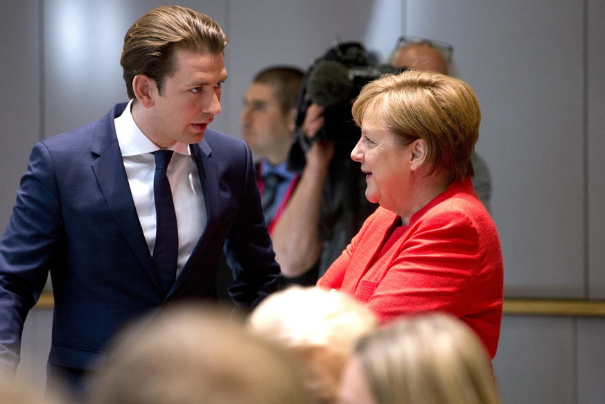 German Chancellor Angela Merkel, right, speaks with Austrian Chancellor Sebastian Kurz during a breakfast meeting at an EU summit in Brussels, Friday, June 29, 2018. European Union leaders were set to ...