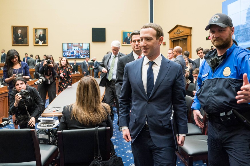 Facebook co-founder and CEO Mark Zuckerberg walks away from his seat during a break from testifying before a House Energy and Commerce Committee hearing on transparency and use of consumer data on Cap ...