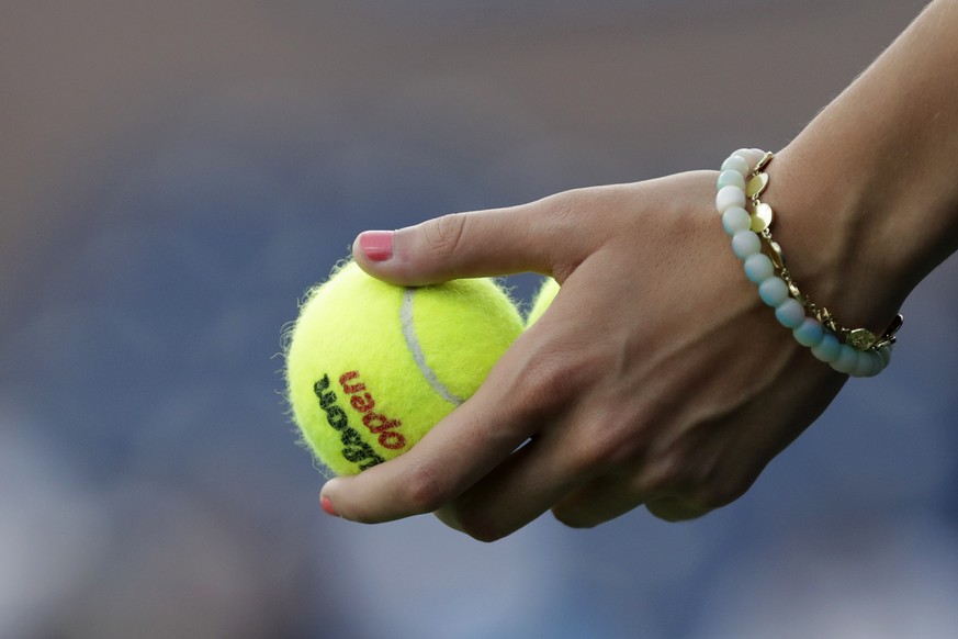 A ball girl holds tennis balls during the match between Dominik Koepfer, of Germany, and Nikoloz Basilashvili, of Georgia, during the third round of the U.S. Open tennis tournament Friday, Aug. 30, 20 ...