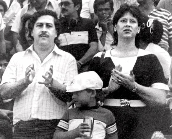 FILE - In this undated file photo, the late Pablo Escobar, former boss of the Medellin drug cartel, his wife Maria Henao and their son Juan Pablo, attend a soccer match in Bogota, Colombia. The widow  ...