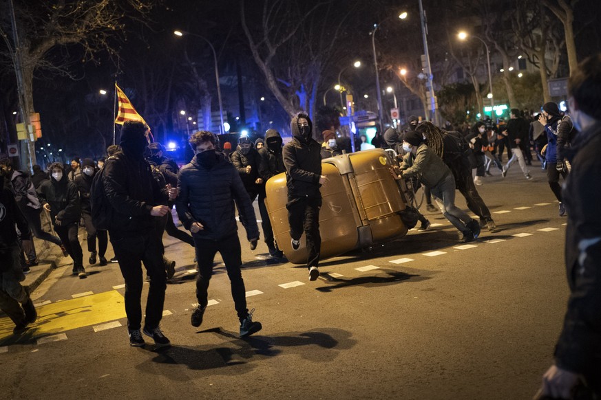 Demonstrators made barricades during clashes with police following a protest condemning the arrest of rap singer Pablo Hasél in Barcelona, Spain, Wednesday, Feb. 17, 2021. Police fired rubber bullets  ...