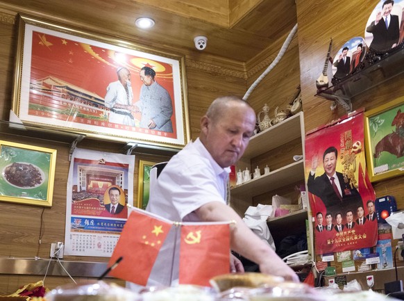Xinjiang Uyghur Autonomous Region Photo taken on July 4, 2018, shows a man at a restaurant decorated with pictures of Chinese government leaders in Urumqi in the country s Xinjiang Uyghur Autonomous R ...