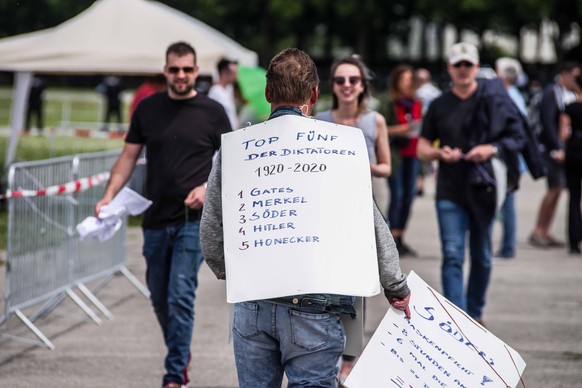 May 23, 2020, Munich, Bavaria, Germany: A demonstrator has a list relating Merkel, Soeder, Honecker, and Bill Gates to Adolph Hitler. After days of back and forth wrangling with the Munich Kreisverwal ...