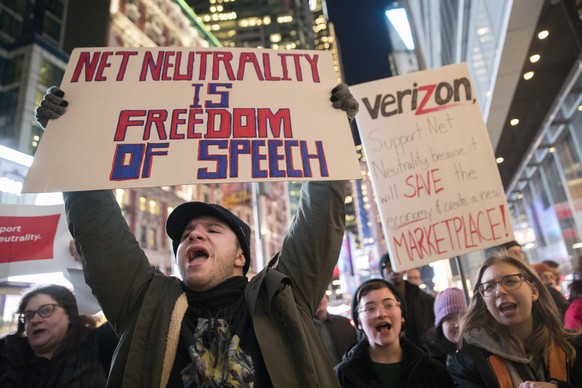 FILE - In this Thursday, Dec. 7, 2017 file photo, Demonstrators rally in support of net neutrality outside a Verizon store in New York. Consumers aren’t likely to see immediate changes following Monda ...