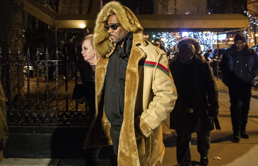 R. Kelly walks to his vehicle after exiting a cigar lounge in Chicago on Monday, Feb. 25, 2019. A suburban Chicago woman posted the $100,000 bail for R. Kelly to be freed from jail while he awaits tri ...