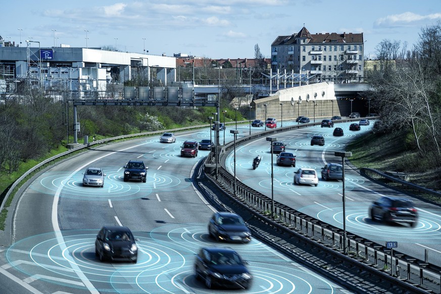 Self driving autonomous cars on multi lane highway. The cars are using radar sensors, wireless communication and artificial intelligence to navigate and communicate with each other.