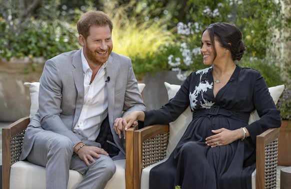 This image provided by Harpo Productions shows Prince Harry, left, and Meghan, Duchess of Sussex, speaking about expecting their second child during an interview with Oprah Winfrey. &quot;Oprah with M ...