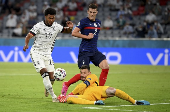 Germany&#039;s Serge Gnabry, left, France&#039;s goalkeeper Hugo Lloris and France&#039;s Benjamin Pavard challenge for the ball during the Euro 2020 soccer championship group F match between France a ...