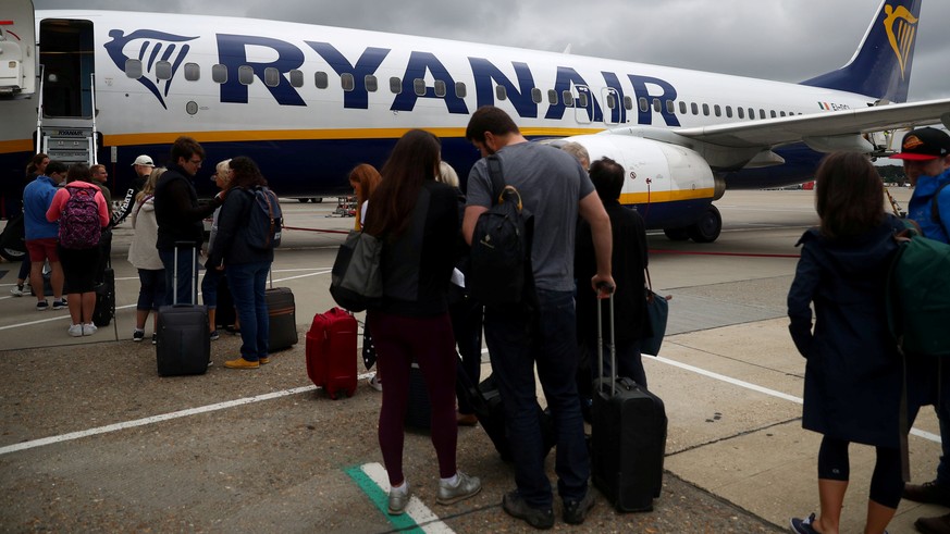 FILE PHOTO: Passengers wait to board a Ryanair flight at Gatwick Airport in London, Britain. Aug 23, 2018. REUTERS/Hannah McKay/File Photo