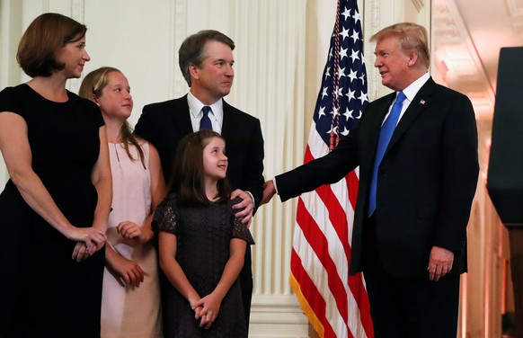 U.S. President Donald Trump talks to Supreme Court nominee judge Brett Kavanaugh, his daughters and his wife Ashley Estes Kavanaugh, in the East Room of the White House in Washington, U.S., July 9, 20 ...