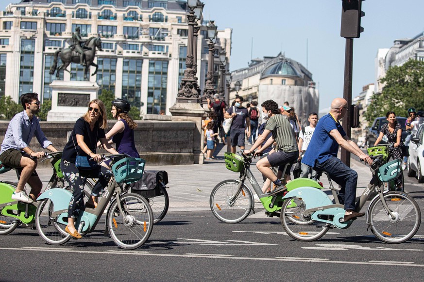 People walk and doing bike in the streets following the nationwide lockdown put into place on March 17, to stop the spread of the novel corona virus COVID-19 pandemic, in Paris on May 30, 2020. PUBLIC ...